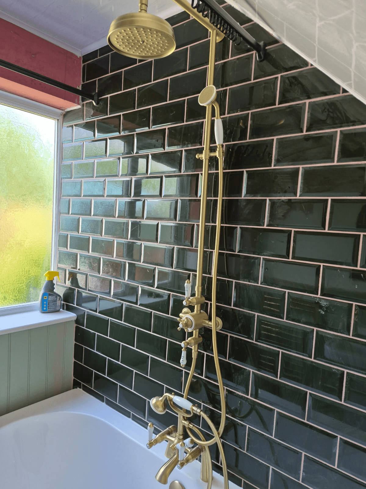 Dark green metro tiles with brass shower
